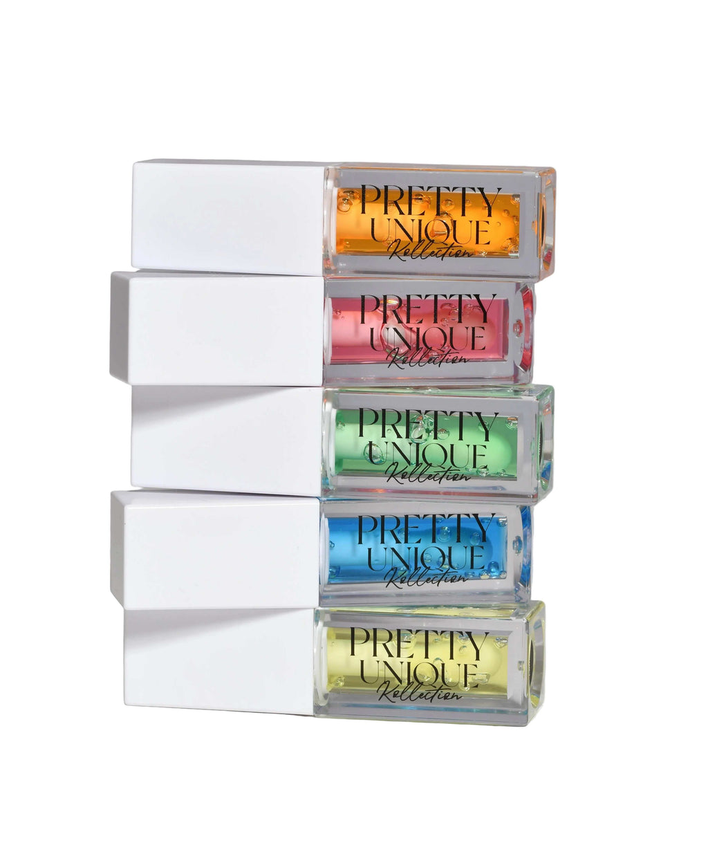 Lip Oil collection in clear rectangular tubes with white caps, showing orange, pink, green, blue and yellow shades